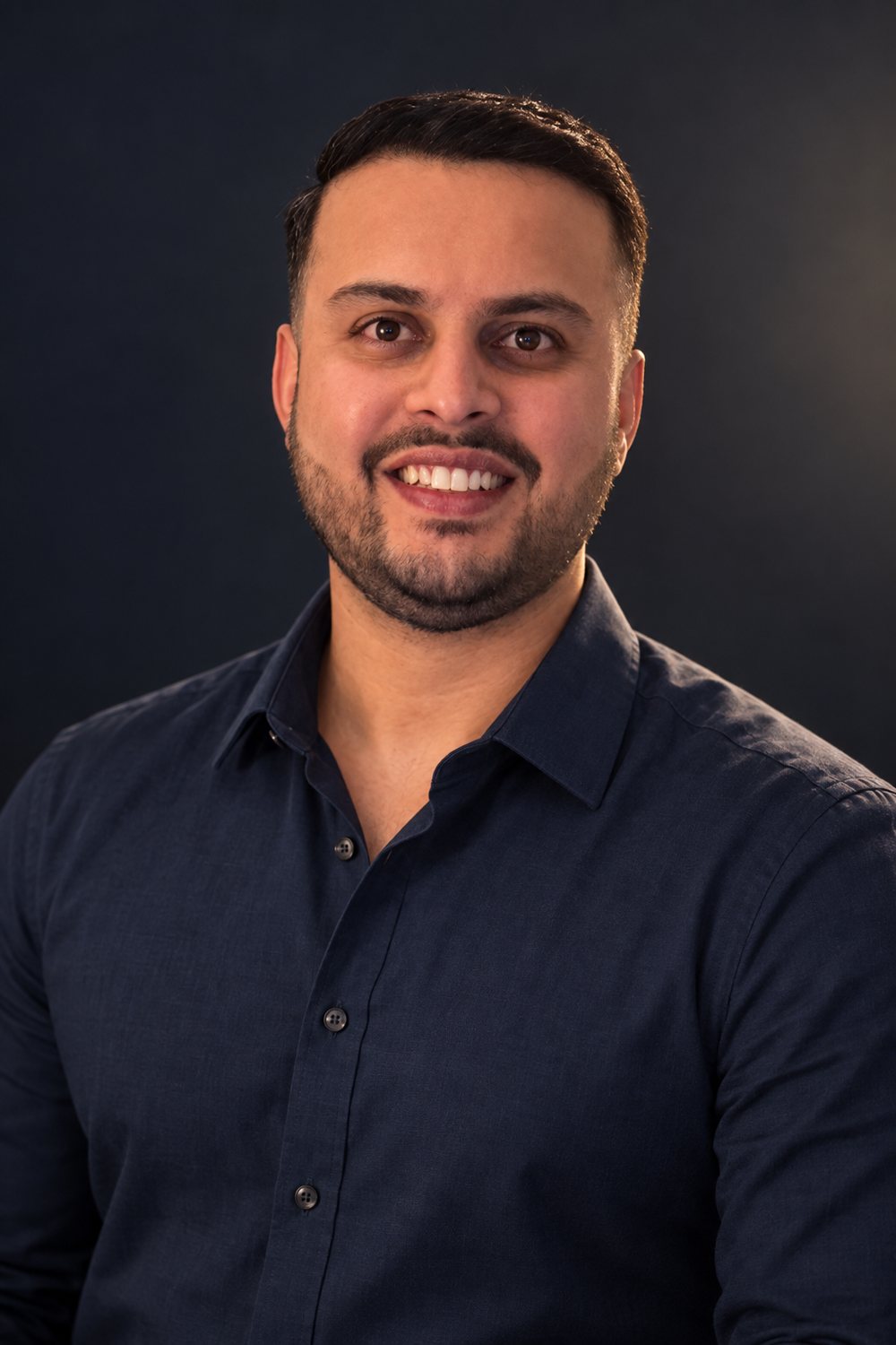 Dil Phagura, photographed against a dark studio background.