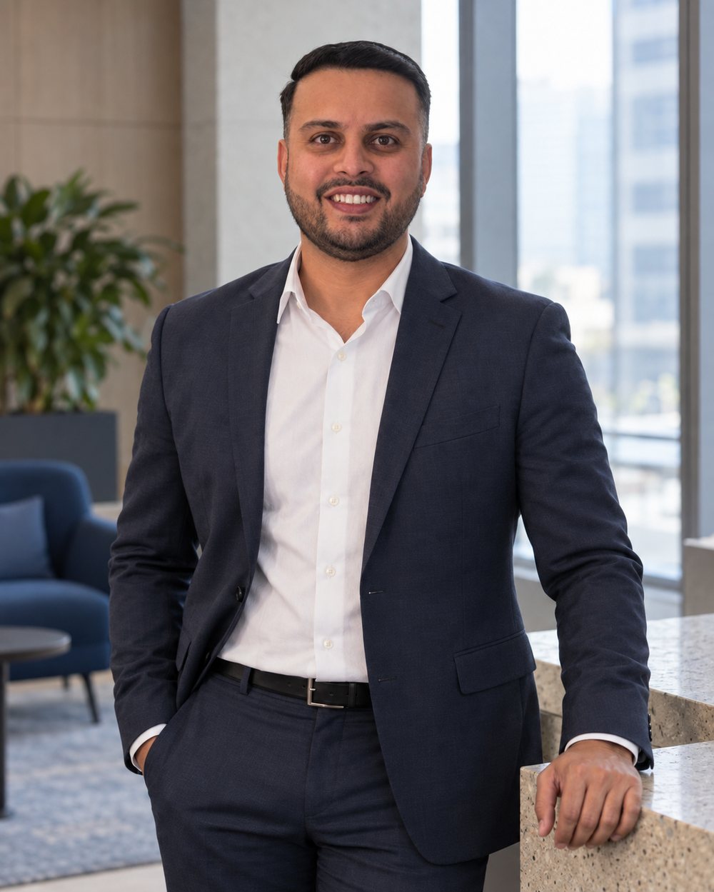 Dil Phagura standing in an office lobby beside a window.